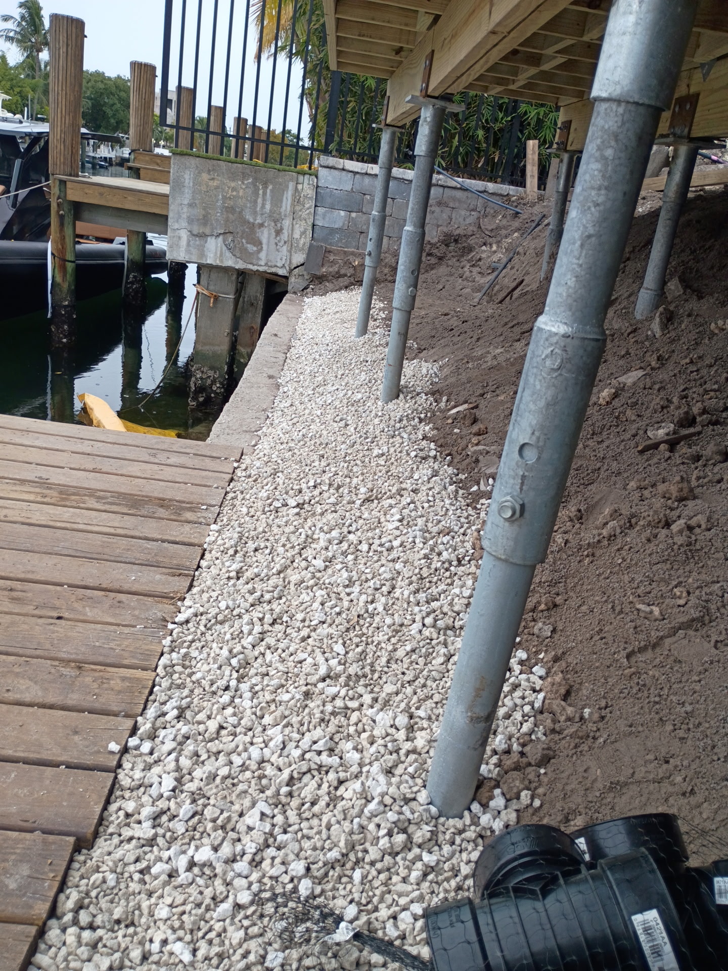 Drainage gravel and aggregate installation near dock