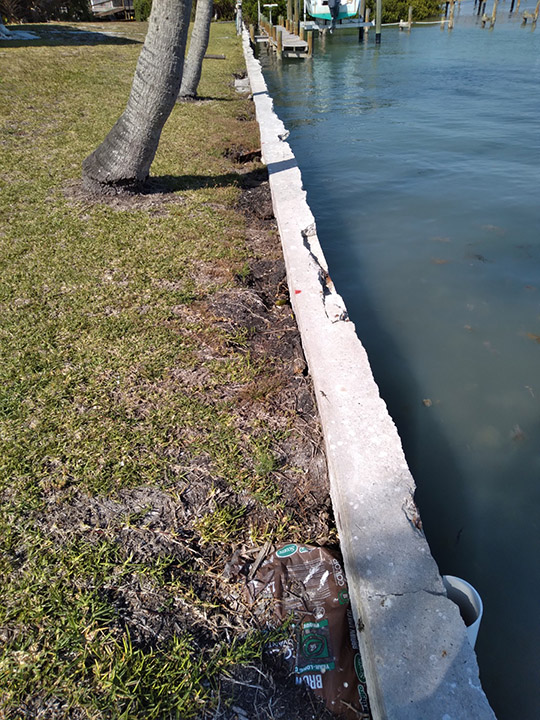 Cracked seawall cap before repair