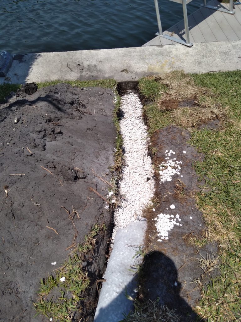 French drain and gravel drainage trench along a seawall