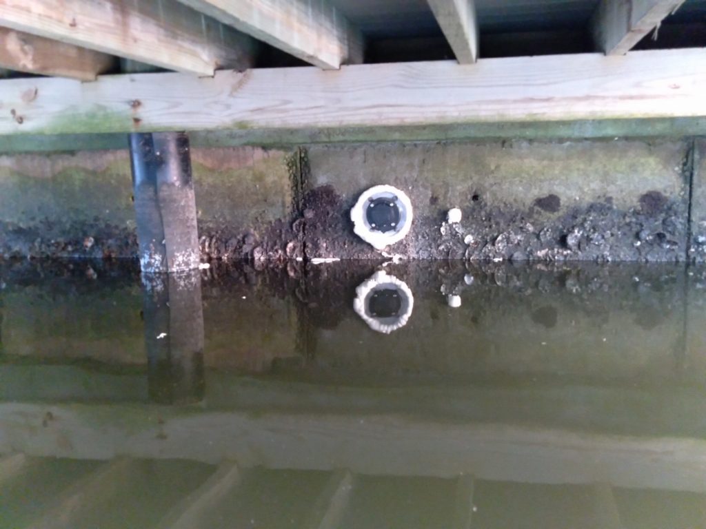 Jet filters installed in a seawall under a dock