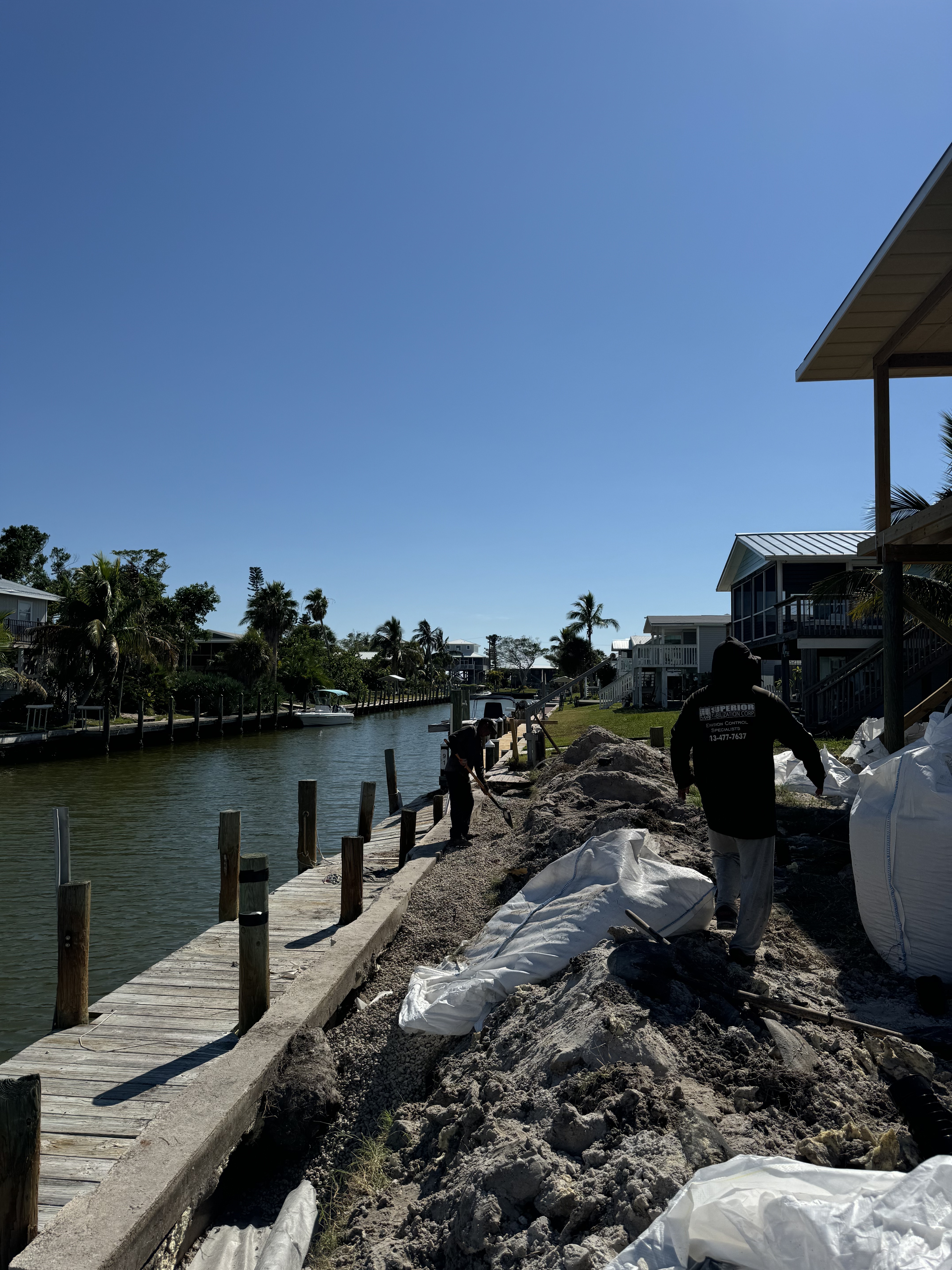 Crew rebuilding seawall and clearing land along Florida canal