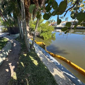 Yellow erosion control boom barrier placed in waterway